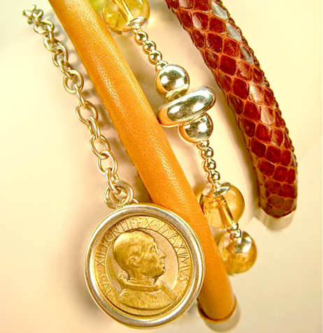 8) Citrine beads set in sterling silver in harmony with torn silk, old coins (each an original), suede and stingray leather.