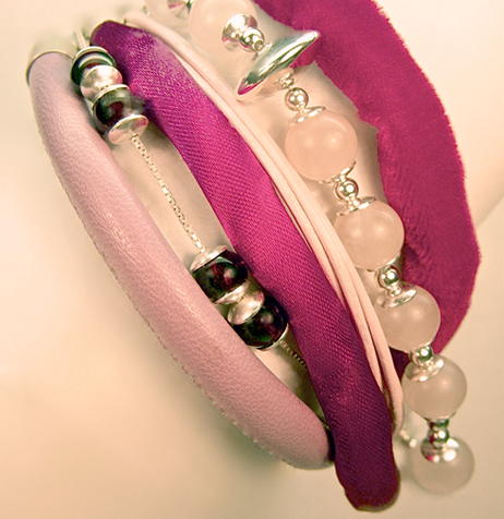 7) garnet and rose quartz beads set in sterling silver, nestled between velvet, satin and the finest leather.

